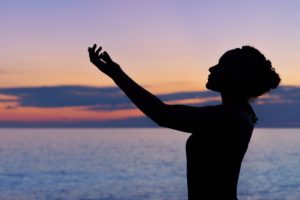 Silhouette of lady praying